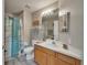 Bright bathroom with a shower, sink, and wood vanity at 10449 Hunters Haven Blvd, Riverview, FL 33578
