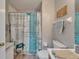 Charming bathroom with a nautical themed shower curtain and neutral walls at 10449 Hunters Haven Blvd, Riverview, FL 33578