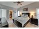 Primary bedroom suite with a ceiling fan, light grey walls, and a walk-in closet at 10449 Hunters Haven Blvd, Riverview, FL 33578