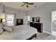 Bright primary bedroom suite with a ceiling fan, light grey walls, and access to the bathroom at 10449 Hunters Haven Blvd, Riverview, FL 33578