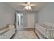 Light and airy Bedroom featuring a crib, changing table, closet, and stylish flooring at 10449 Hunters Haven Blvd, Riverview, FL 33578