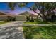 Charming single-story home with well-manicured lawn and a lovely sunset backdrop at 10449 Hunters Haven Blvd, Riverview, FL 33578
