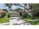 Charming single-story home with a well-manicured lawn, front garden, and attached garage at 10449 Hunters Haven Blvd, Riverview, FL 33578