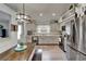 Bright kitchen with stainless steel appliances and adjacent wood table and bench seating at 10449 Hunters Haven Blvd, Riverview, FL 33578