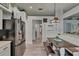 Updated kitchen featuring stainless steel appliances, an eat-in table and bench, and stylish decor at 10449 Hunters Haven Blvd, Riverview, FL 33578