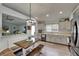 Open kitchen featuring stainless appliances, an eat-in table and bench, and modern decor at 10449 Hunters Haven Blvd, Riverview, FL 33578