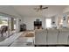 Living room with sliding glass doors to outdoor patio, wood-look floors, and kitchen access at 10449 Hunters Haven Blvd, Riverview, FL 33578