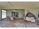 Cozy screened-in patio with hanging chair, fan, and outdoor dining, perfect for relaxation and outdoor gatherings at 10449 Hunters Haven Blvd, Riverview, FL 33578