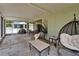 Expansive screened-in patio with multiple seating areas, providing ample space for outdoor entertaining and relaxation at 10449 Hunters Haven Blvd, Riverview, FL 33578