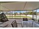 Screened-in patio featuring a hanging chair and outdoor dining, offering a comfortable space to unwind and enjoy the weather at 10449 Hunters Haven Blvd, Riverview, FL 33578