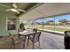 Relaxing screened-in patio with ceiling fan and outdoor dining set, perfect for enjoying the backyard views at 10449 Hunters Haven Blvd, Riverview, FL 33578