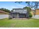 Spacious backyard featuring a screened-in patio, lush green lawn, and privacy fence, perfect for outdoor enjoyment at 11121 Running Pine Dr, Riverview, FL 33569