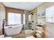 Modern bathroom with freestanding tub, walk-in glass shower, and stylish fixtures at 11121 Running Pine Dr, Riverview, FL 33569