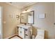 Bright bathroom features a white vanity, decorative mirror, and stylish wicker basket storage at 11121 Running Pine Dr, Riverview, FL 33569