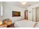 Contemporary bedroom featuring sleek furniture, a wall-mounted television, and neutral tones at 11121 Running Pine Dr, Riverview, FL 33569