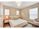 Cozy bedroom with neutral tones, stylish decor, a comfortable bed, and natural light at 11121 Running Pine Dr, Riverview, FL 33569