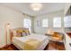 Comfortable bedroom with modern furnishings, bright windows and dark wood flooring at 11121 Running Pine Dr, Riverview, FL 33569
