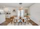 Open dining area with modern lighting, stylish seating, and seamless flow to the kitchen and living space at 11121 Running Pine Dr, Riverview, FL 33569