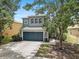 Charming two-story home with a well-manicured lawn, mature trees, and a two-car garage at 11121 Running Pine Dr, Riverview, FL 33569