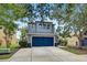 Beautiful two-story home has a blue garage door, an inviting front entrance, and mature landscaping at 11121 Running Pine Dr, Riverview, FL 33569