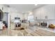 Spacious kitchen showcasing white cabinets, granite countertops, stainless appliances, and wood flooring at 11121 Running Pine Dr, Riverview, FL 33569