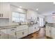 Bright kitchen features white cabinets, updated countertops, and a farmhouse sink beneath a window at 11121 Running Pine Dr, Riverview, FL 33569