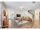 Inviting living room with wood floors, shiplap wall, comfortable seating, and natural light at 11121 Running Pine Dr, Riverview, FL 33569