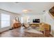 Inviting living room with wood floors, shiplap wall, comfortable seating, and natural light at 11121 Running Pine Dr, Riverview, FL 33569