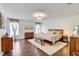 Spacious main bedroom with hardwood floors, soft lighting, and elegant decor creating a peaceful ambiance at 11121 Running Pine Dr, Riverview, FL 33569