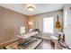Well-lit office space with modern desk, accent wall, and guitar hanging on the wall at 11121 Running Pine Dr, Riverview, FL 33569