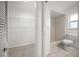 Neutral tiled bathroom features tiled shower and walk-in closet at 1142 Lancer Ln, Tarpon Springs, FL 34689