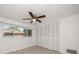 Bedroom features tiled floors, a ceiling fan, one window, and a closet at 1142 Lancer Ln, Tarpon Springs, FL 34689