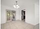 Dining area with a modern chandelier, French doors leading to the patio, and convenient access to the kitchen at 1142 Lancer Ln, Tarpon Springs, FL 34689