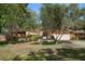 Inviting single-story home featuring lush landscaping, a front porch, and a neatly kept lawn at 1142 Lancer Ln, Tarpon Springs, FL 34689