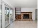 Living room area with brick fireplace and sliding glass door at 1142 Lancer Ln, Tarpon Springs, FL 34689