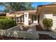 Inviting front entrance with a covered patio area, decorative rock landscaping, and a modern front door with glass detailing at 1142 Lancer Ln, Tarpon Springs, FL 34689