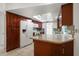 Well-lit kitchen with modern appliances, granite countertops, and dark wood cabinets at 1142 Lancer Ln, Tarpon Springs, FL 34689