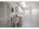 White laundry room offers sink, washer, dryer and storage at 1142 Lancer Ln, Tarpon Springs, FL 34689