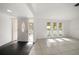 Open-concept living area with large windows, tile flooring, and a seamless transition from the foyer at 1142 Lancer Ln, Tarpon Springs, FL 34689