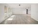 Spacious living room featuring tile floors, large windows for natural light, and an open layout for versatile use at 1142 Lancer Ln, Tarpon Springs, FL 34689