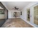 A screened in patio featuring a ceiling fan, and access to the backyard through sliding glass doors at 1142 Lancer Ln, Tarpon Springs, FL 34689