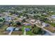 An aerial community shot of a neighborhood with lush greenery and well-spaced homes at 11635 Willmington Blvd, Port Charlotte, FL 33981