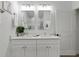 Bright bathroom featuring a double vanity with modern fixtures and framed mirrors at 11635 Willmington Blvd, Port Charlotte, FL 33981