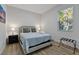 Comfortable bedroom with neutral decor, side tables with lamps, and natural lighting at 11635 Willmington Blvd, Port Charlotte, FL 33981