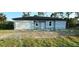 A single-story home with a two-car garage featuring a grey exterior and clean architectural lines at 11635 Willmington Blvd, Port Charlotte, FL 33981