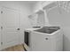 Functional laundry room equipped with modern washer and dryer and wire rack at 11635 Willmington Blvd, Port Charlotte, FL 33981