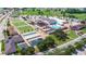 An aerial view of the community center, swimming pool, shuffleboard court, and well manicured lawns at 1201 Peridot Ln, Sun City Center, FL 33573