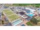 Aerial view of the community center with pool, shuffleboard, sports field, and parking at 1201 Peridot Ln, Sun City Center, FL 33573