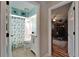 Charming bathroom features updated vanity with marble top and shower with colorful shower curtain at 1201 Peridot Ln, Sun City Center, FL 33573