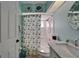 The bathroom features a tub/shower combo, updated vanity with marble top, and coastal decor at 1201 Peridot Ln, Sun City Center, FL 33573